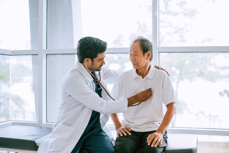 A therapist guiding a senior through pulmonary rehabilitation