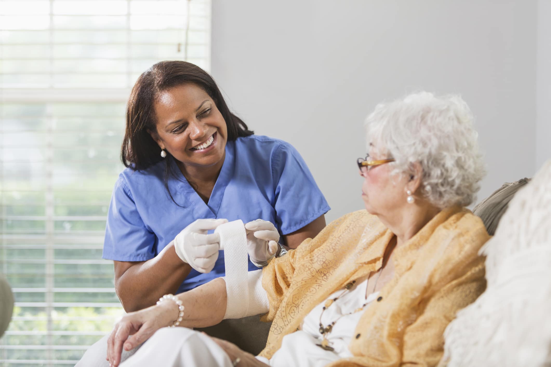 Nurse providing wound care to a senior resident