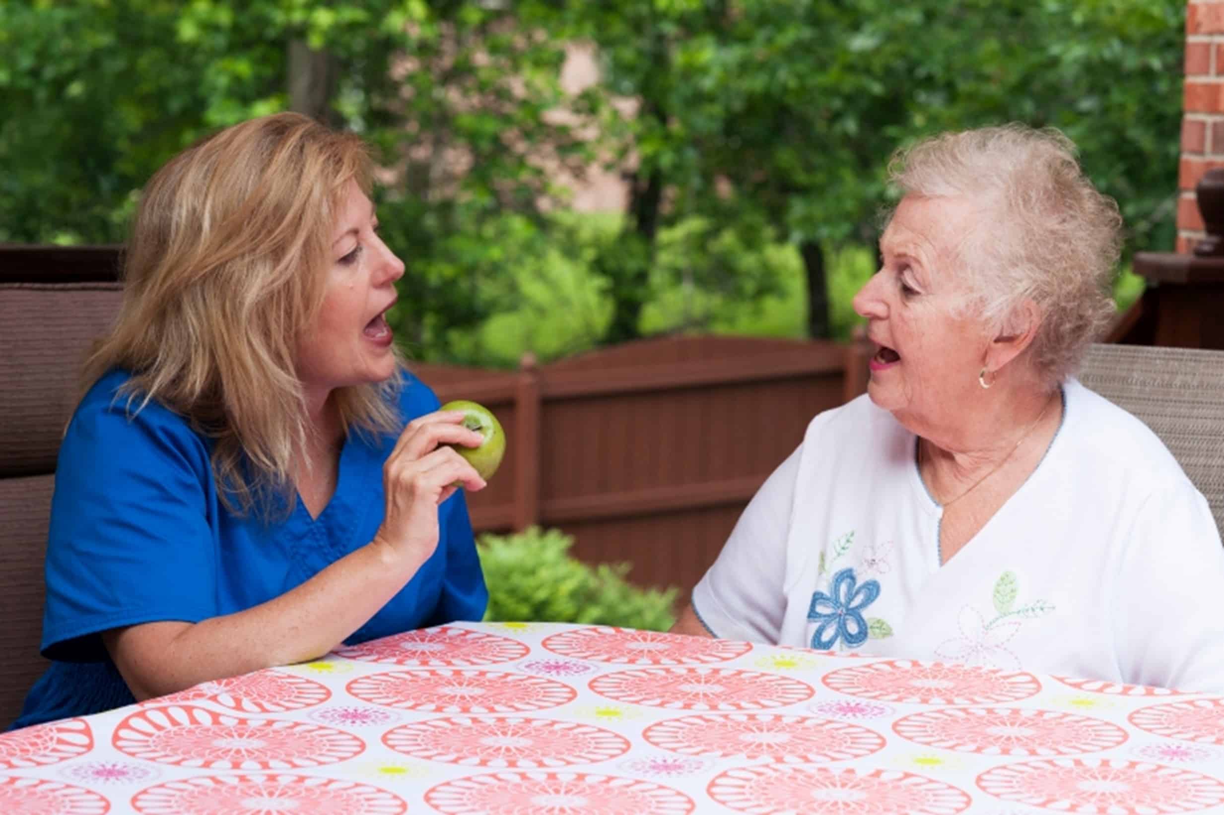 A speech therapist working with a senior patient