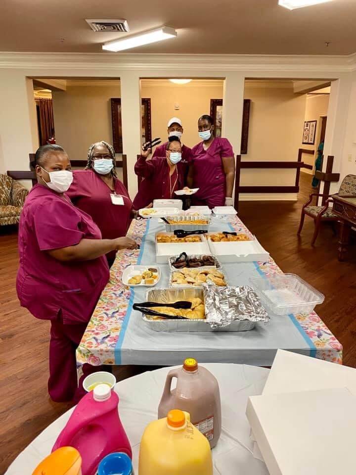 Nursing home team in Ruston, LA, serving food to residents, highlighting their commitment to care.