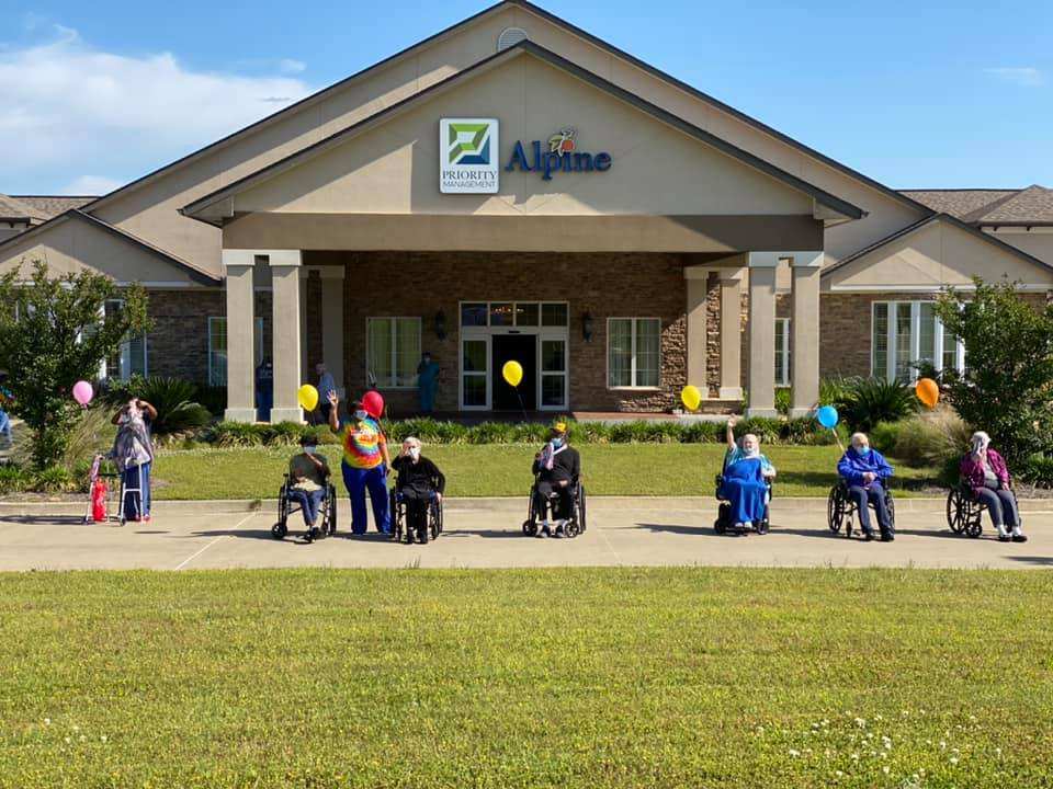 Seniors gather outside with balloons at Alpine Skilled Nursing and Rehabilitation in Ruston, LA.
