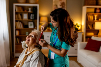 An occupational therapist helping a patient comb hair during a therapy session in Ruston, LA
